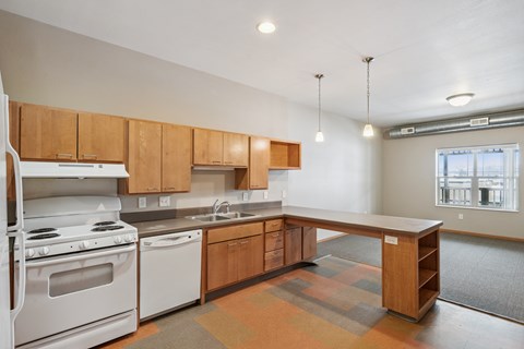 A kitchen with wooden cabinets and a white stove top oven.