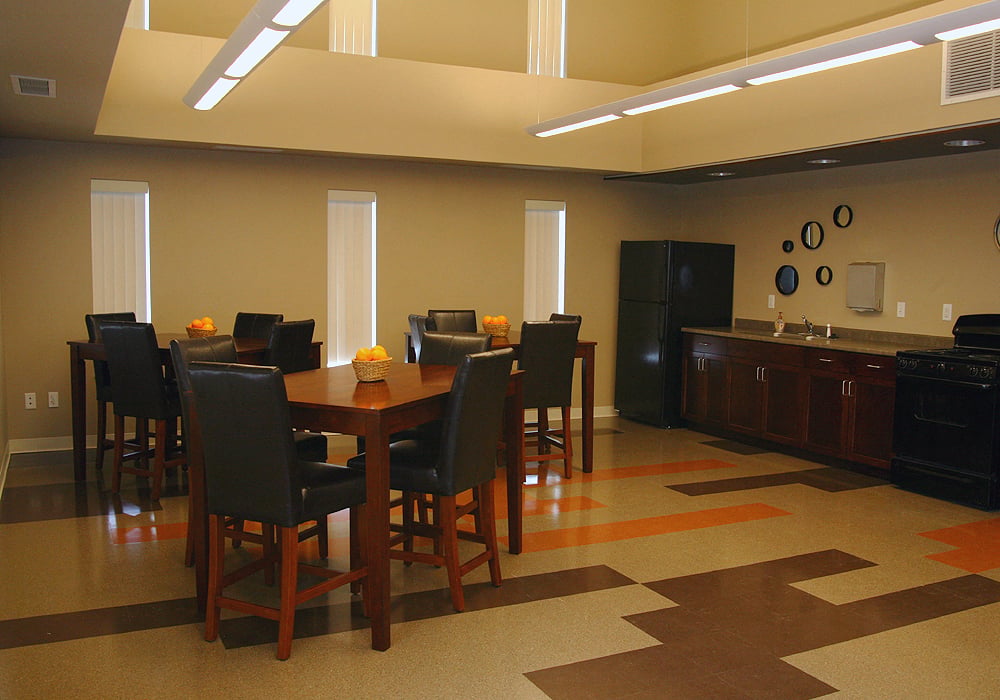 A kitchen with a brown and white floor.