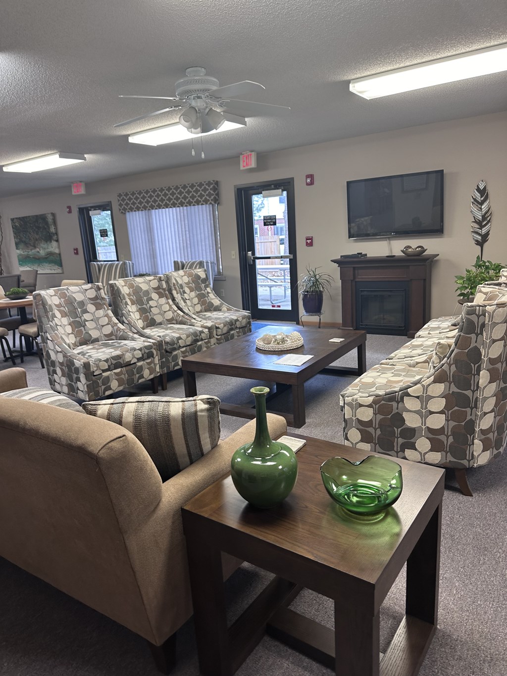A living room with a couch, chairs, and a coffee table.