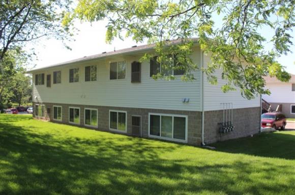 A two-story house with a white siding and grey trim.