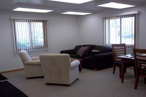 a living room with a couch and a table and chairs