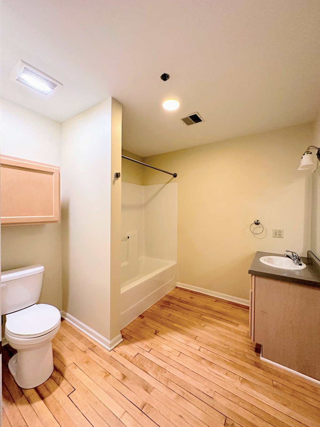 a bathroom with a toilet and a shower and a sink
