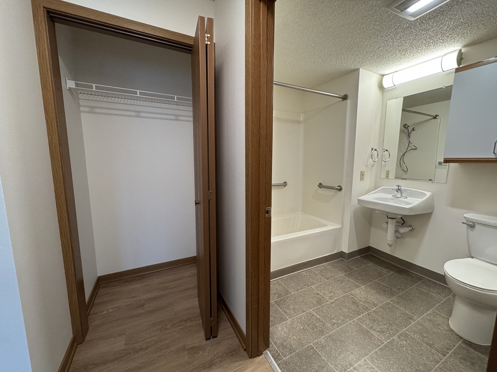 A bathroom with a toilet, sink, and bathtub.