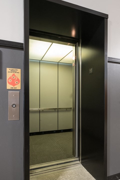 A sign on a door warns to not use the elevator.