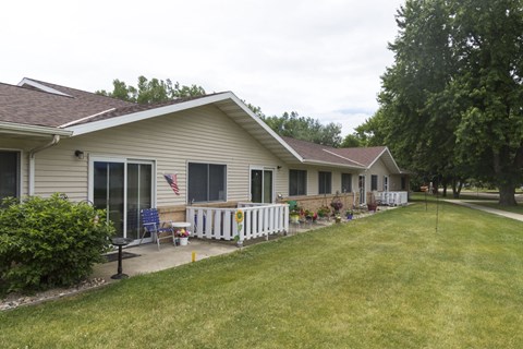 A house with a white fence and a flag on the front porch.