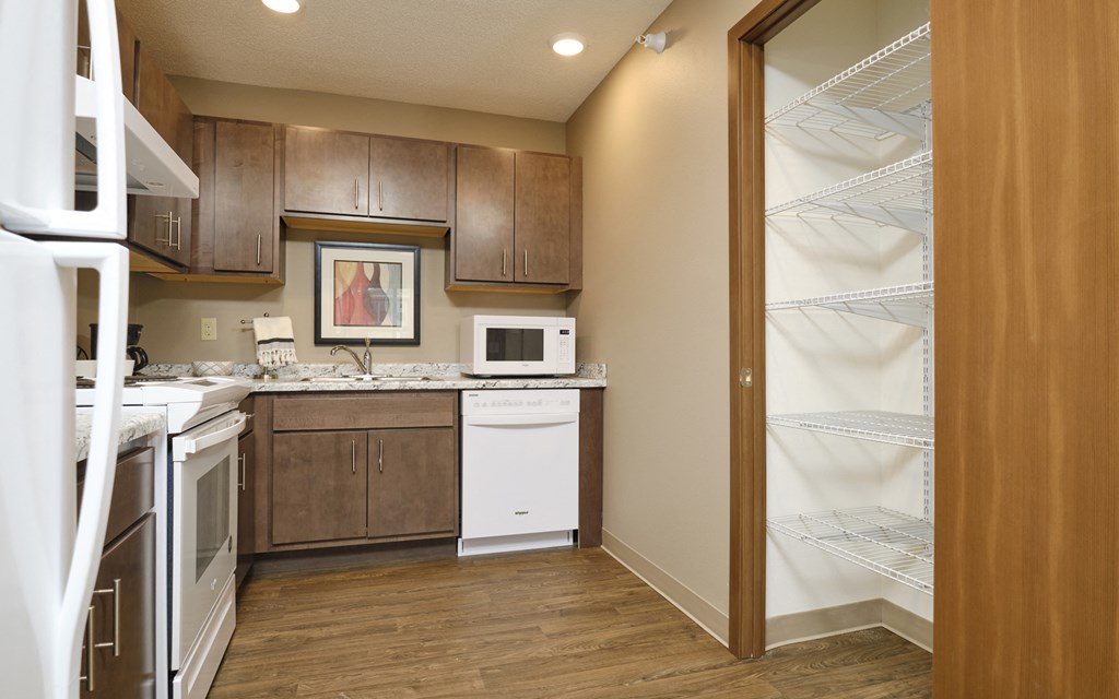 a kitchen with white appliances and wooden cabinets