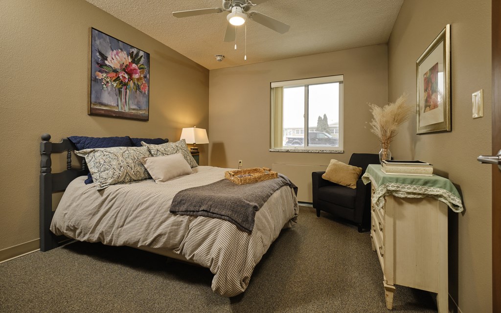 a bedroom with a bed and a chair