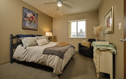 a bedroom with a bed and a chair
