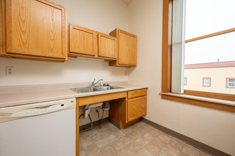 A kitchen with wooden cabinets and a washing machine.