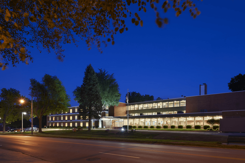 a large brick building with trees in front of it