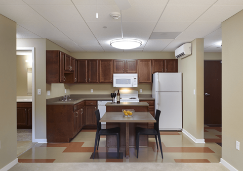 a kitchen with a dining table and a refrigerator