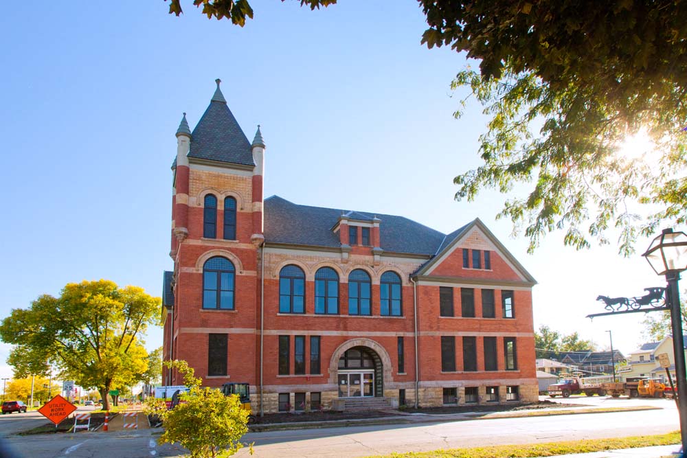 Roosevelt School is a two story brick building with large historic windows and a tower in the northeast corner of the building.