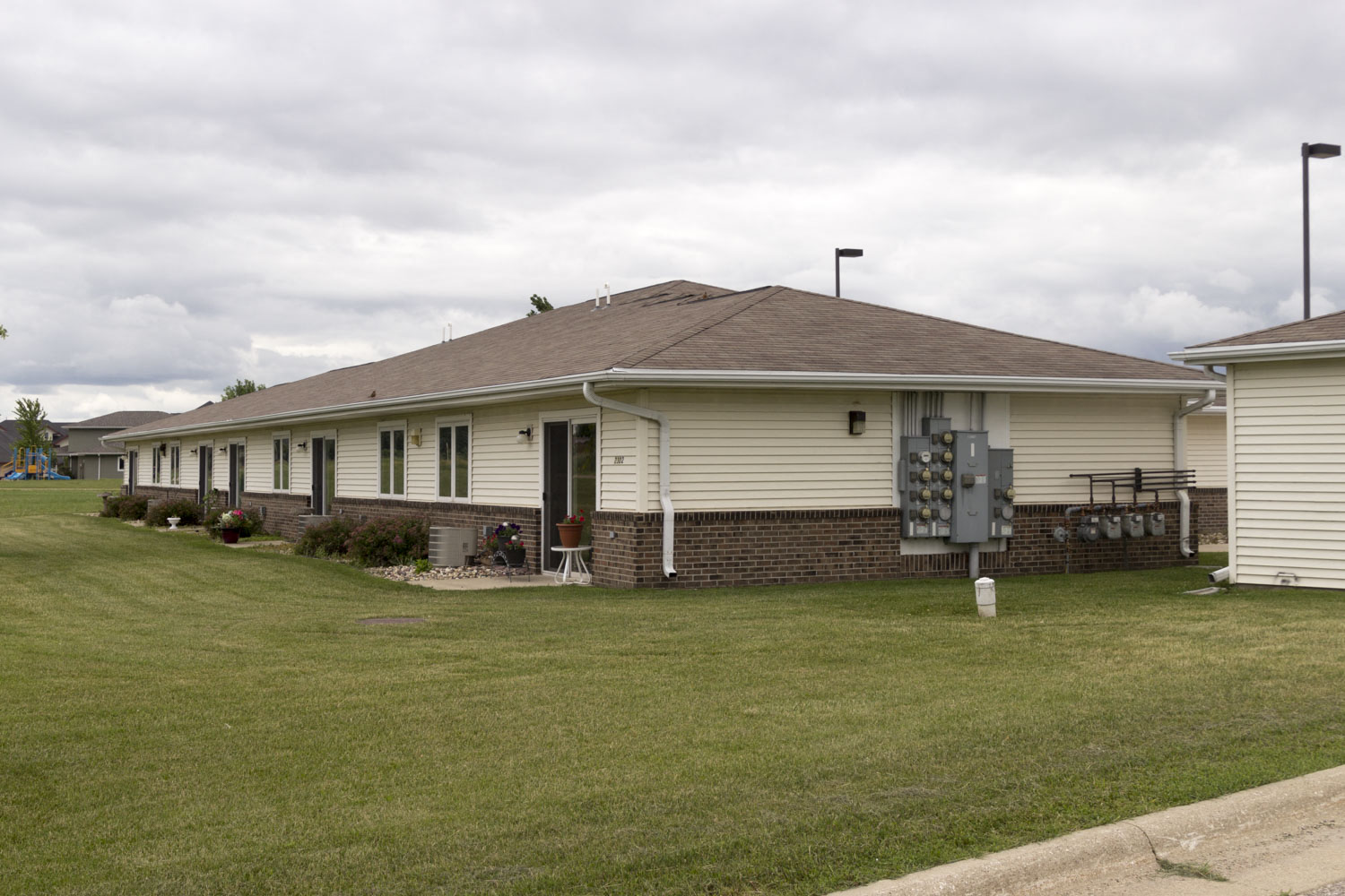 A house with a brown roof and a white garage door.