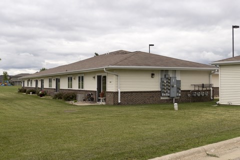 A house with a brown roof and a white garage door.