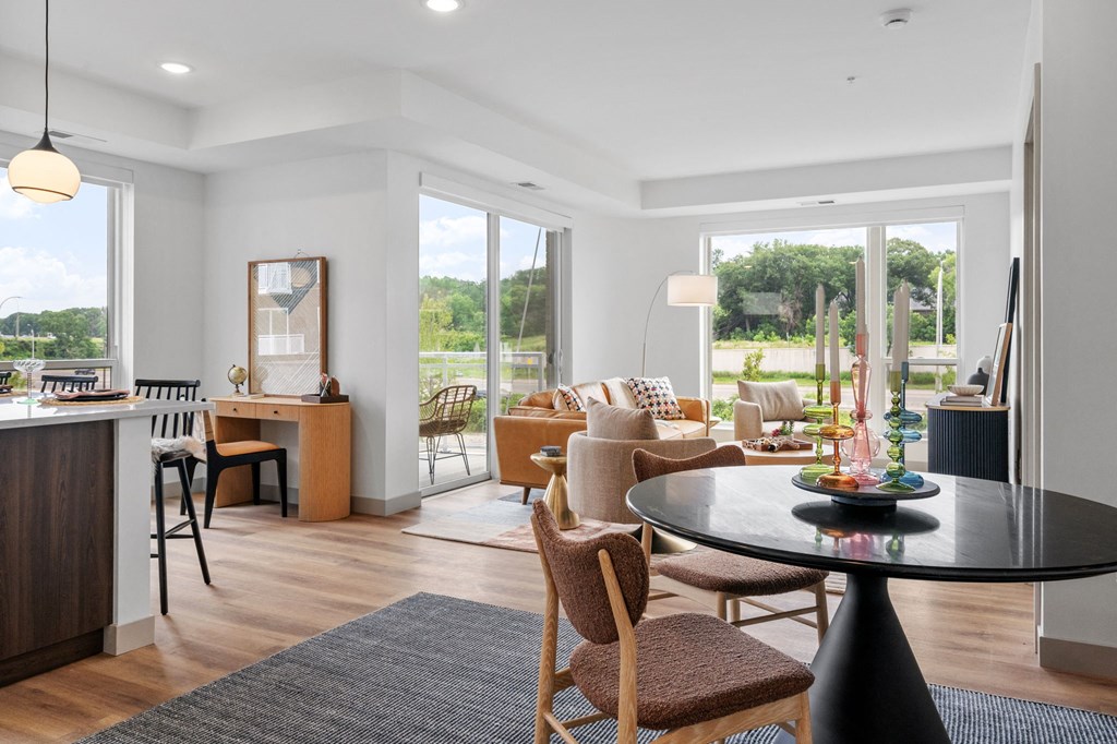 a living room and dining room with a table and chairs at The Mera, St Louis Park, Minnesota
