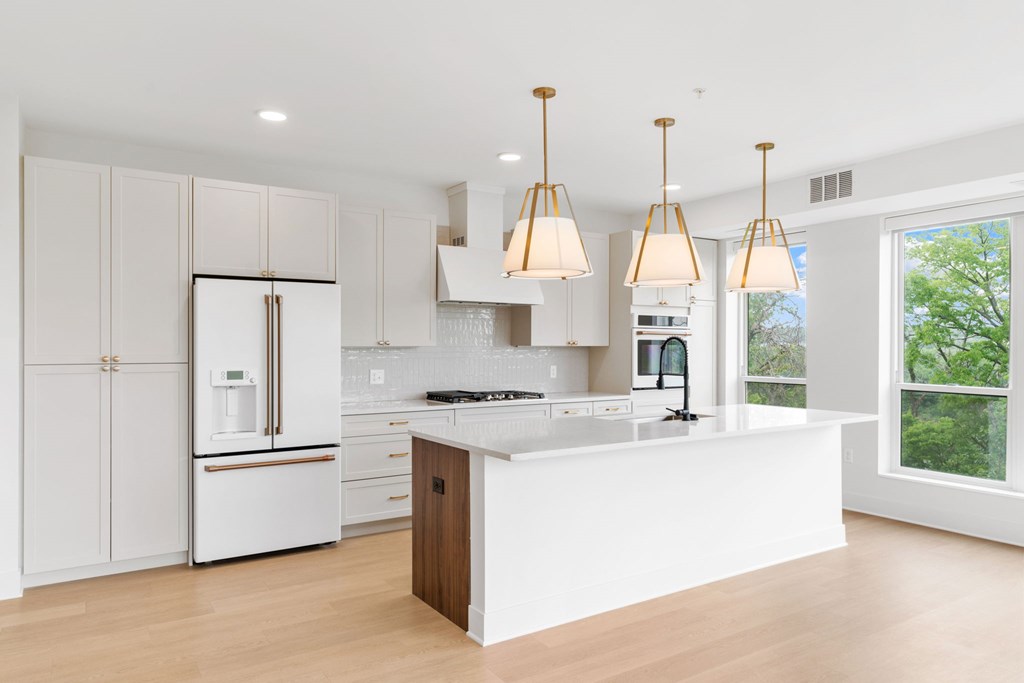 A modern kitchen with white cabinets and a central island.