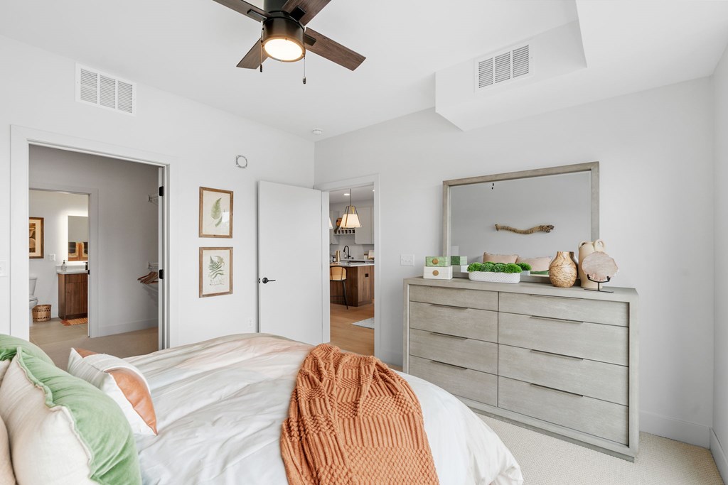 A bedroom with a queen-sized bed in a one-bedroom, one-bathroom apartment home at Lilia in Lilydale, MN 55118