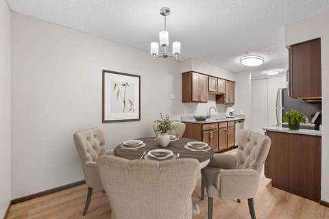 Kitchen and dining room in a renovated apartment home at Oakwood Apartments in Plymouth, MN  55447