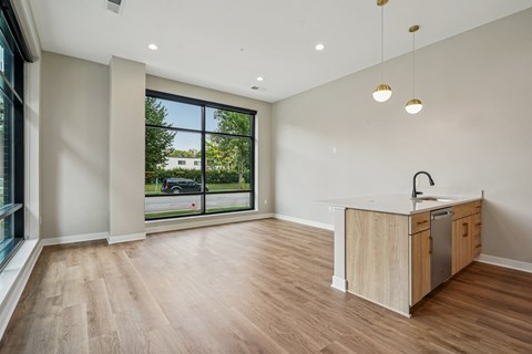 A kitchen with a wooden counter and cabinets is shown.