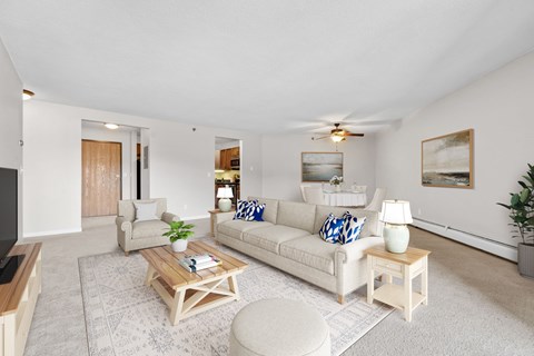 A living room with a white couch and a coffee table.