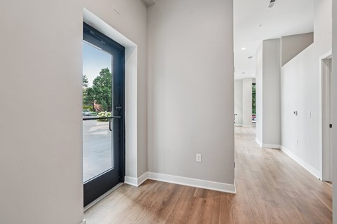 A room with a sliding glass door leading to a parking lot.