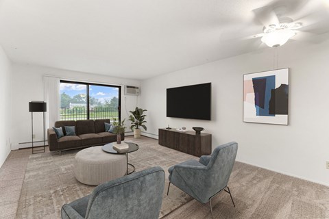 A living room with a grey chair and a brown sofa.