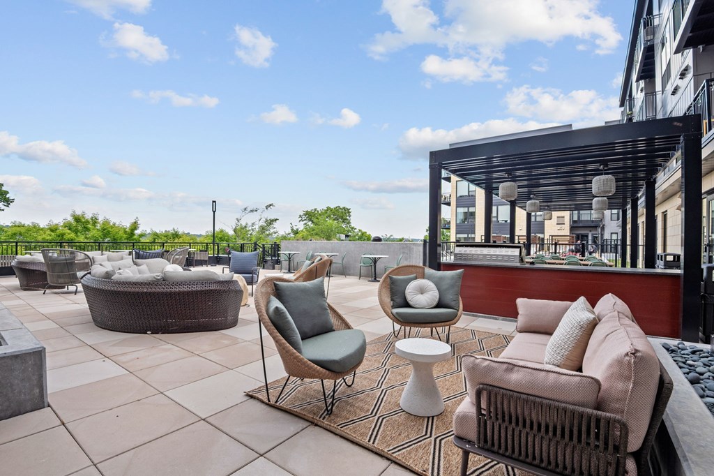 Outdoor Pooldeck and Spa with Grills and Lounge Chairs at Lilia Apartments in Lilydale, MN 55118