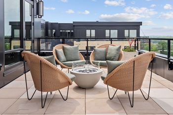 Top floor terrace attached to The Parlour and The Tea Room with fire pits and lounge chairs at Lilia Apartments in Lilydale, MN 55118