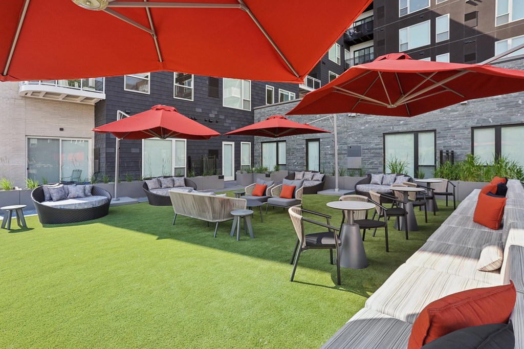 Sundeck with lounge chairs and umbrellas at The Mera in St. Louis Park, 55426