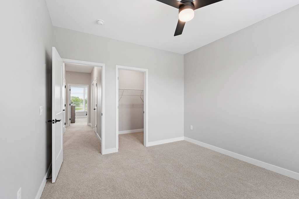 A room with a ceiling fan and carpeted floor. at Townhomes at Preserve, Rogers, MN