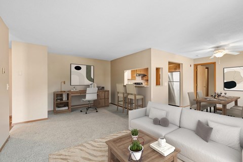 A living room with a white couch and a coffee table.