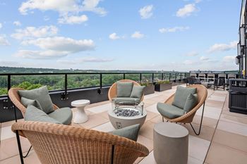 Top floor terrace attached to The Parlour and The Tea Room with fire pits and lounge chairs at Lilia Apartments in Lilydale, MN 55118