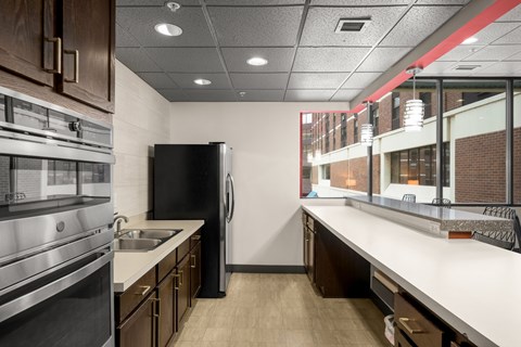 A modern kitchen with a black refrigerator and stainless steel appliances.