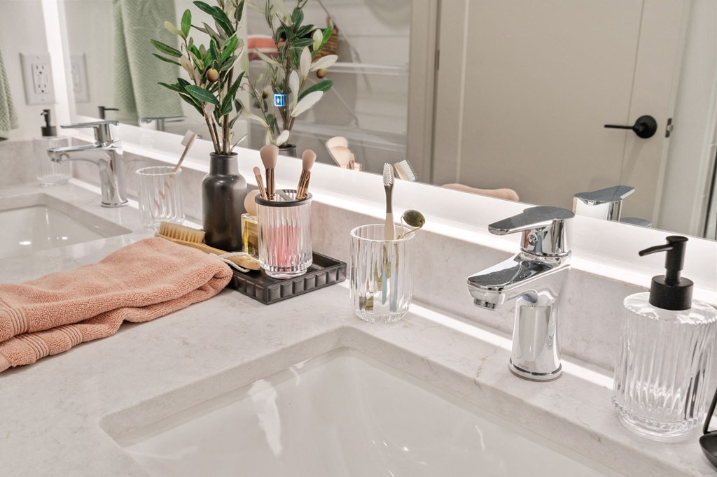 a bathroom with a sink and a mirror at The Mera, St Louis Park