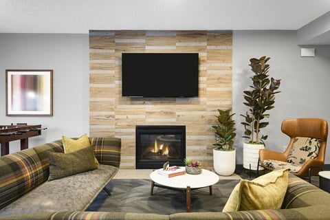 a living room with a fireplace and a tv above it