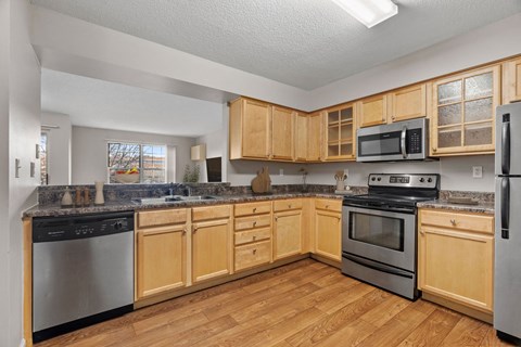 A kitchen with wooden cabinets and stainless steel appliances.