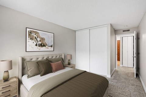 A bedroom with a large bed and a painting on the wall.