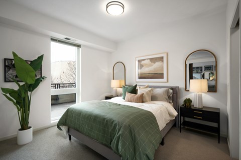 Bedroom with green bedding and arched mirror at The Flats at West End Apartments, Minnesota, 55416