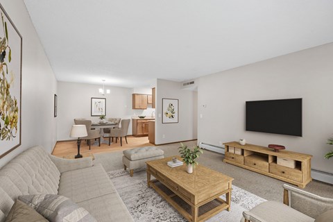 Kitchen, dining, and living rooms in a renovated apartment home at Oakwood Apartments in Plymouth, MN  55447