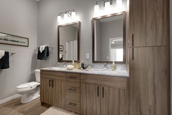 Modern Bathrooms With Ample Lighting At Nuvelo at Parkside Apartments In Apple Valley, MN