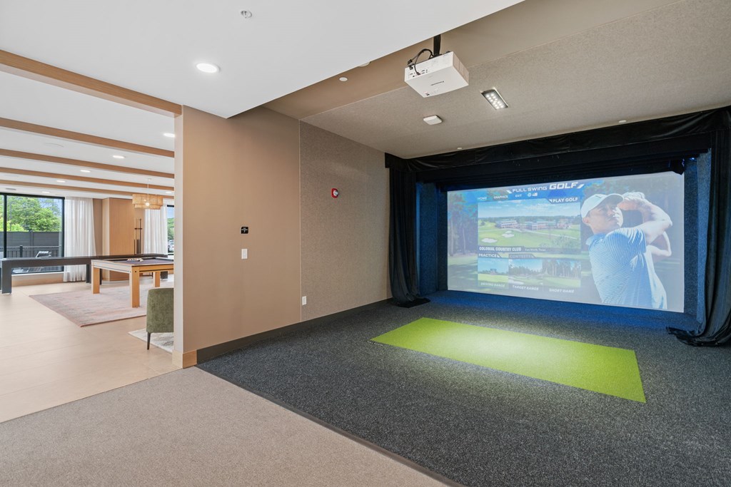 The Game and Golf Simulator with seating in the Game Lounge, a reservable community room at Lilia in Lilydale, MN 55118