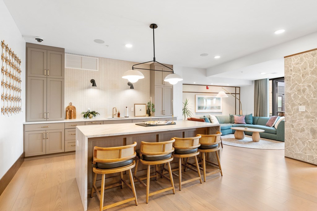 The kitchen and lounge spaces in the Clubroom, a reservable community room at Lilia in Lilydale, MN 55118