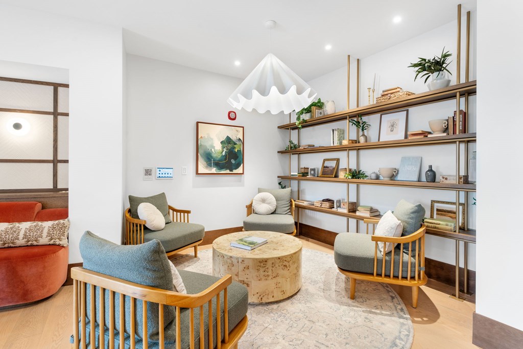 Comfortable seating in the Clubroom, a reservable community amenity at Lilia in Lilydale, 55118