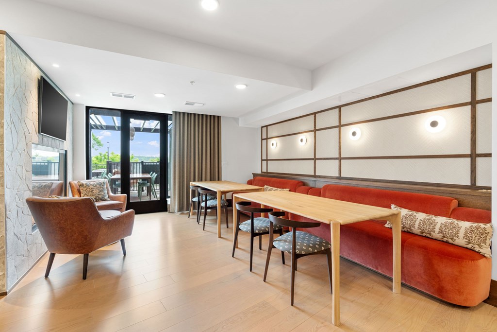 Bench seating across from the fireplace in the Clubroom, a reservable community room at Lilia in Lilydale, MN 55118
