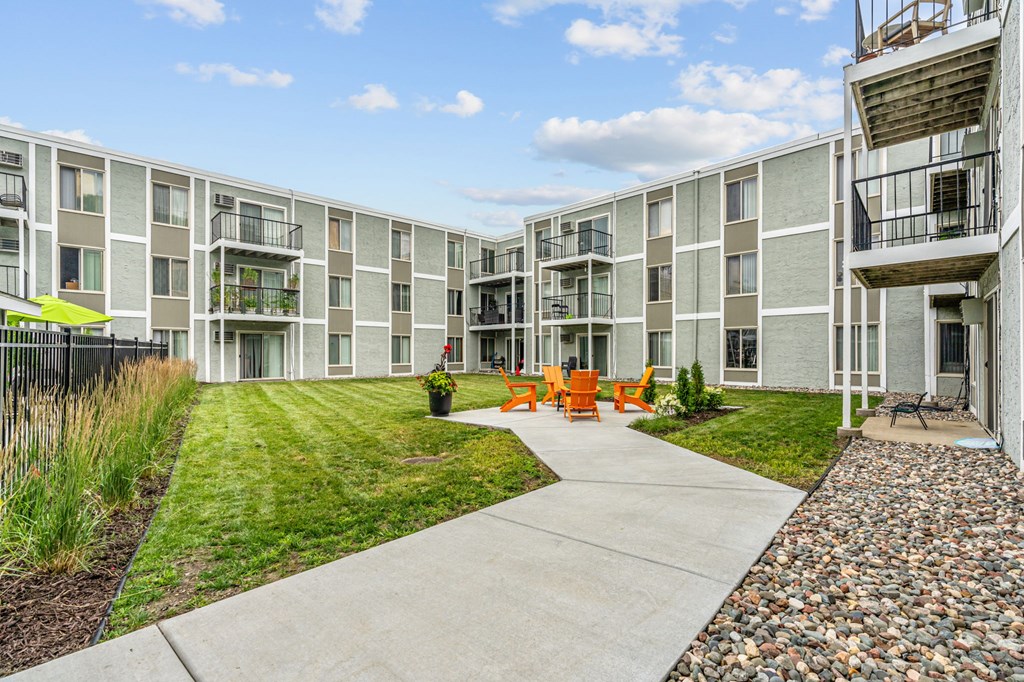 Courtyard with lounge chairs and fire pits at Lou Park, St. Louis Park, MN, 55426