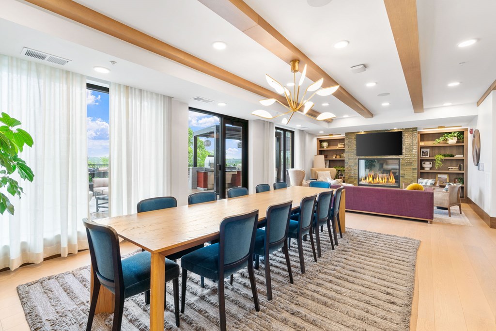 The long dining table overlooking the seating and fireplace in the Private Dining Room, a reservable community room at Lilia in Lilydale, MN 55118