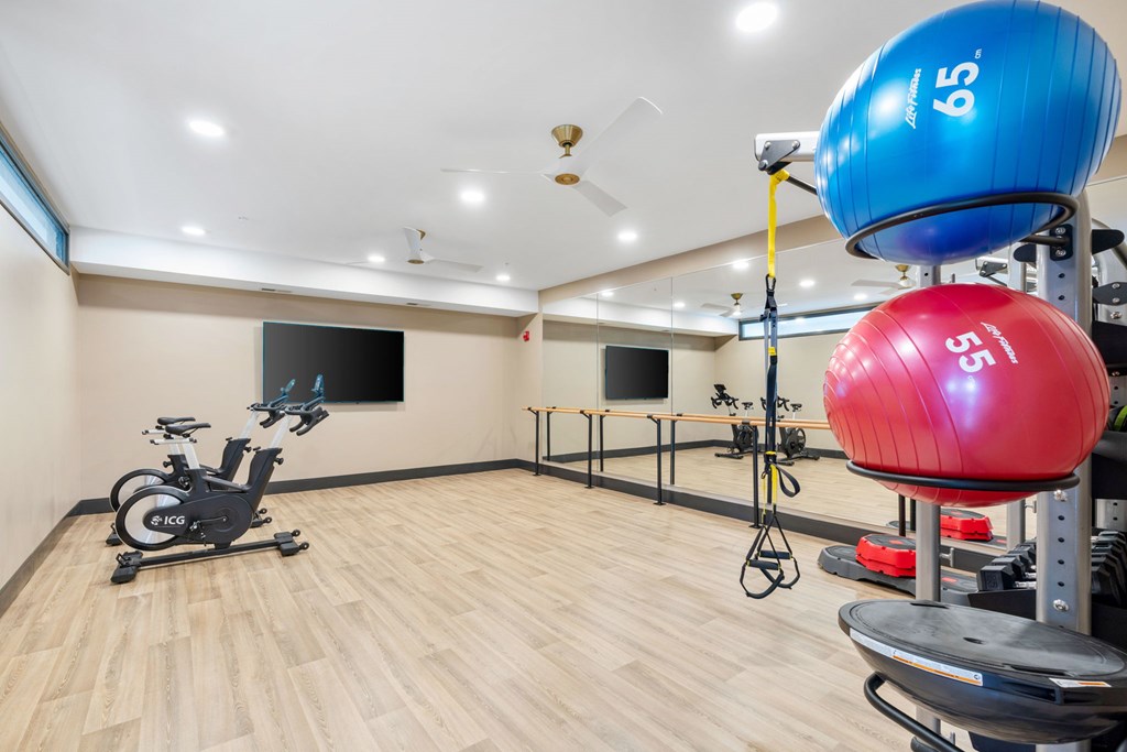 The spin and yoga studio attached to the resort-style luxury 24-hour fitness center at Lilia in Lilydale, MN 55118, with cardio equipment, free weights, and exercise machines.