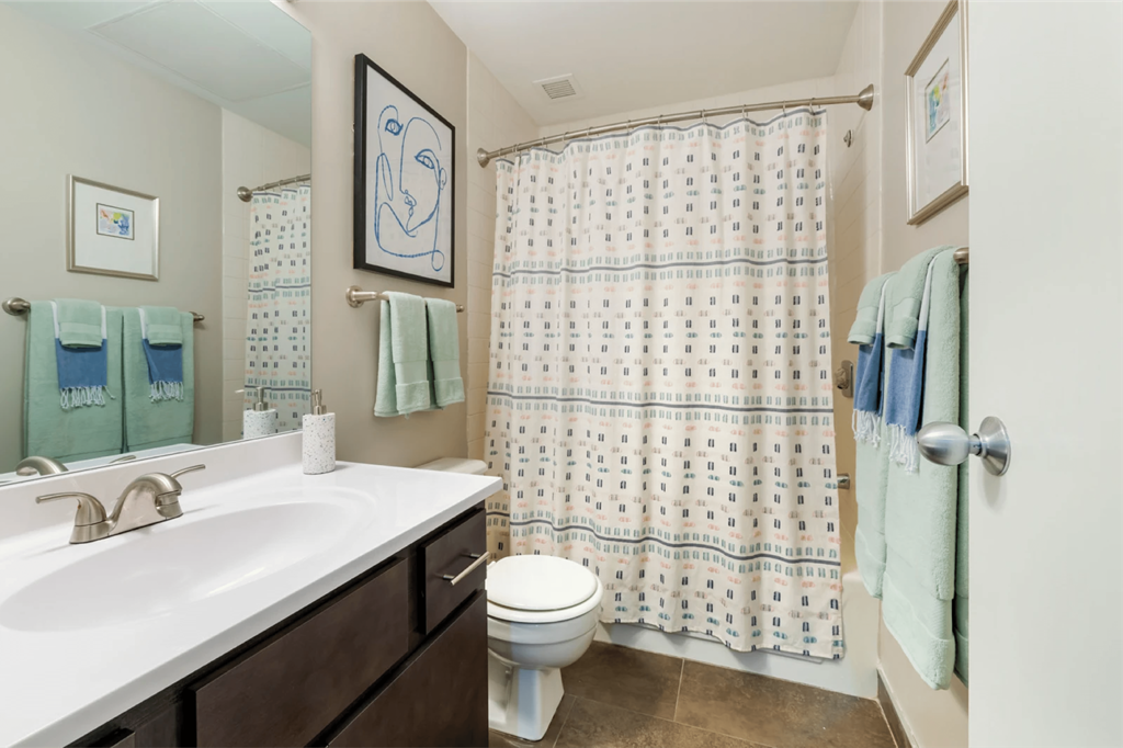 a bathroom with a shower and a sink and a toilet  at The Cosmopolitan, St Paul, Minnesota
