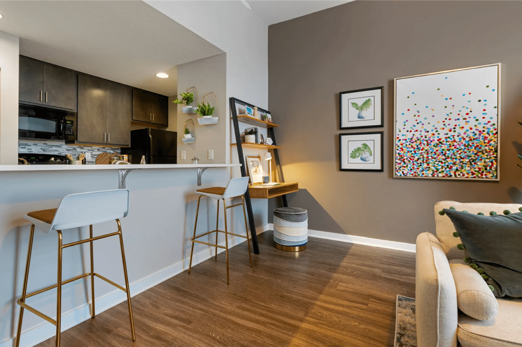 a living room with a bar area and a kitchen  at The Cosmopolitan, St Paul
