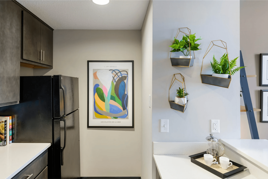 kitchen with stainless steel appliances and white countertops at theolan apartments